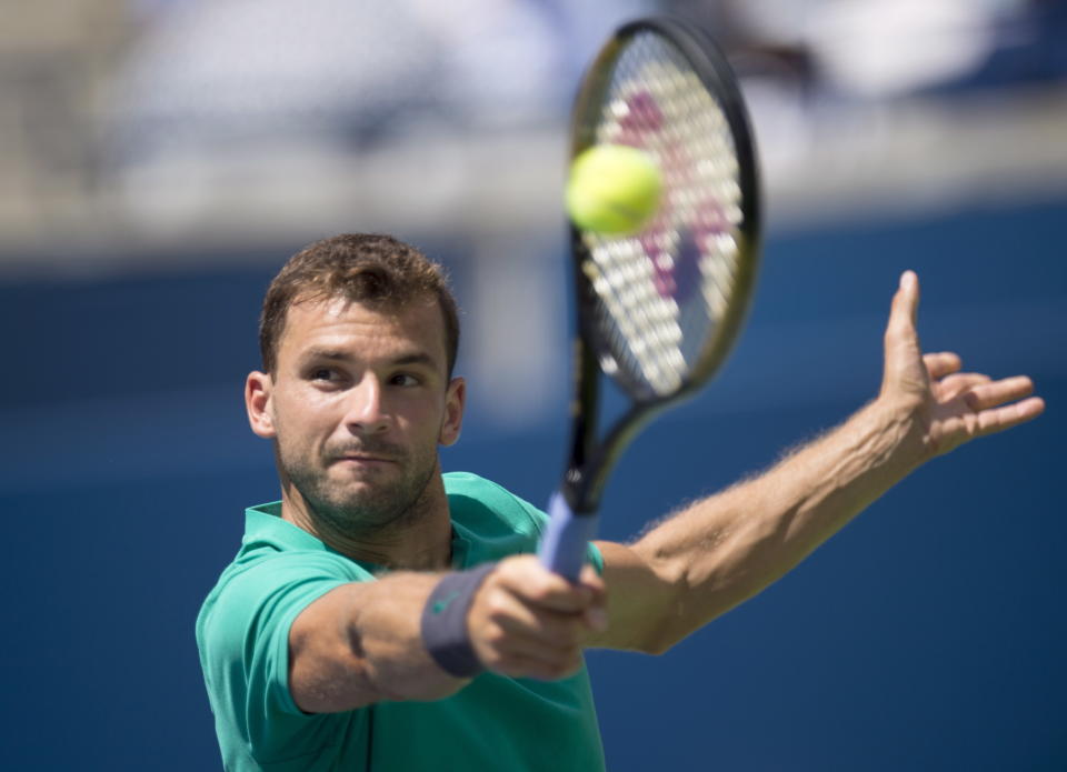 Grigor Dimitrov of Bulgaria hits a backhand on his way to being defeated by Kevin Anderson of South Africa during Rogers Cup quarterfinal tennis tournament action in Toronto on Friday, Aug. 10, 2018. (Frank Gunn/The Canadian Press via AP)