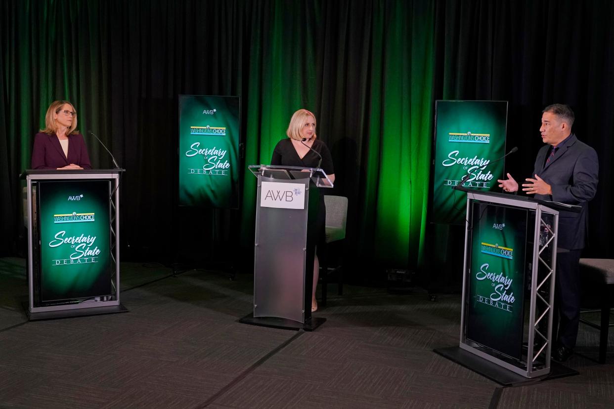 Washington Secretary of State Steve Hobbs, right, a Democrat, and Pierce County Auditor Julie Anderson, left, running as a nonpartisan, take part in a debate on Wednesday in Olympia, with Melissa Santos, center, of Axios Local, moderating.