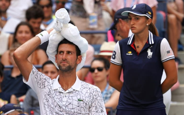 Survivor: Novak Djokovic cools off during his win over Joao Sousa in the fourth round of the US Open on Monday