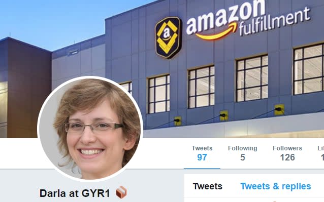 A screenshot of the @AmazonFCDarla Twitter account shows a middle-aged woman with pale skin, dark blonde hair and frameless glasses smiling widely. The first tweet says: "What bothers me most about unions is there's no ability to opt out of dues! As a single mother with two boys I'm barely scraping by as it is, and now unions want to come to Amazon and make them pay a piece of my salary. No thanks!" - Telegraph/Twitter