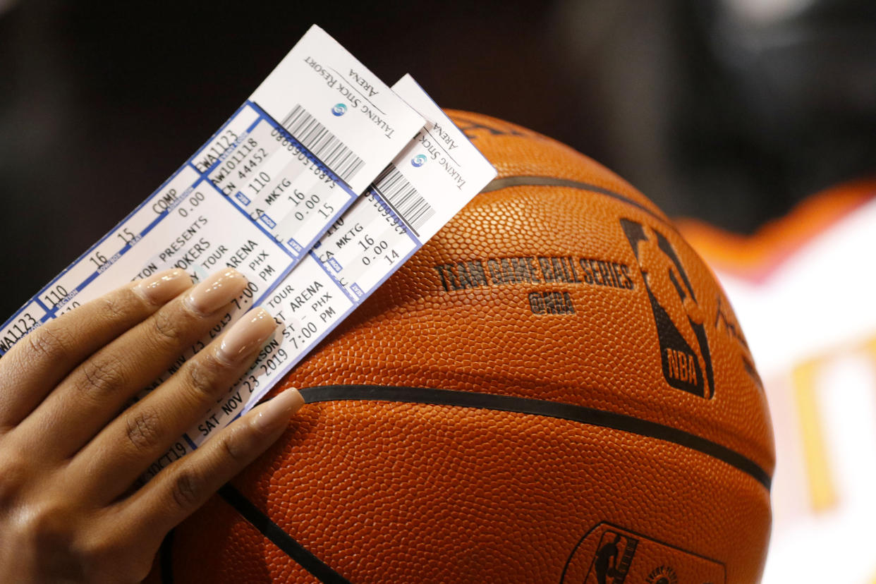 Phoenix Suns' tickets and an NBA basketball against Miami Heat during the first half of an NBA basketball game Thursday, Nov. 7, 2019, in Phoenix. (AP Photo/Darryl Webb)