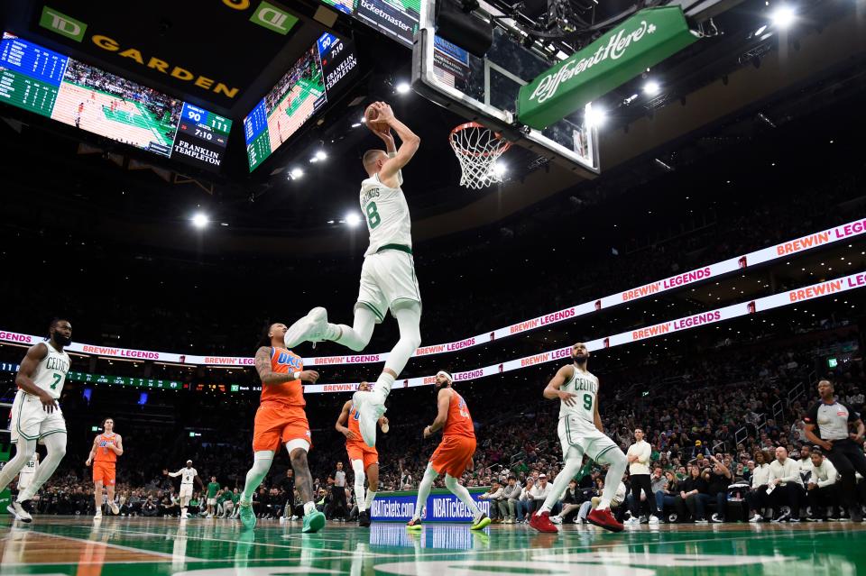 Celtics center Kristaps Porzingis (8) dunks the ball during the second half of a 135-100 win against the Thunder on Wednesday night at TD Garden in Boston.
