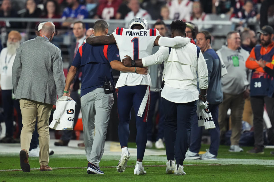 New England Patriots wide receiver DeVante Parker (1) is helped off the field during a game against the Arizona Cardinals, Monday, Dec. 12, 2022, in Glendale, Ariz. (AP Photo/Ross D. Franklin)