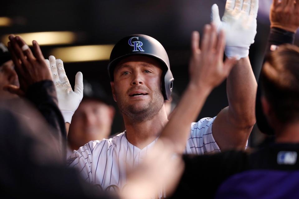 Colorado Rockies' Matt Holliday is congratulated as he returns to the dugout after hitting a solo home run off Los Angeles Dodgers starting pitcher Clayton Kershaw in the second inning of a baseball game Friday, Sept. 7, 2018, in Denver. (AP Photo/David Zalubowski)