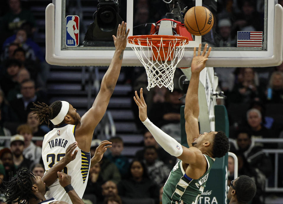 Milwaukee Bucks forward Giannis Antetokounmpo puts up a shot against the Indiana Pacers' Myles Turner during the first half of an NBA basketball game, Monday, Jan. 1, 2024, in Milwaukee. (AP Photo/Jeffrey Phelps)