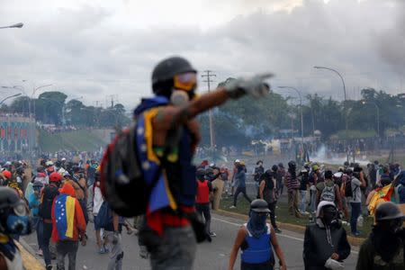 Demonstrators clash with riot security forces while rallying against Venezuelan President Nicolas Maduro's government in front of an Air Force base in Caracas, Venezuela, June 24, 2017. REUTERS/Ivan Alvarado