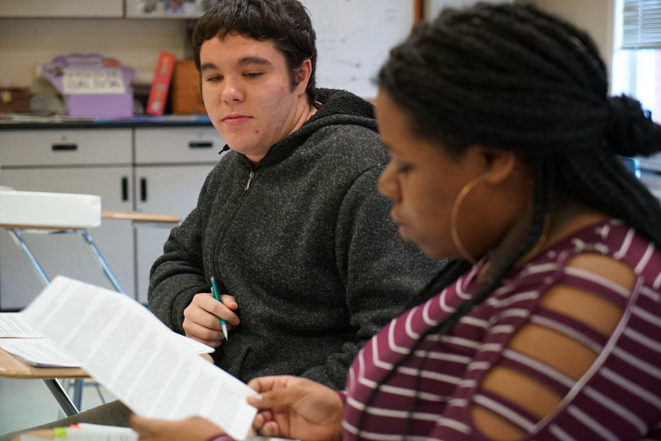 Joseph Tucker watches as Makizah Cotton makes an argument in civics class at Chatham Central High School in Bear Creek, N.C., on Tuesday, Nov. 5, 2019. The 10th-graders were debating whether President Trump should be impeached. (AP Photo/Allen G. Breed)