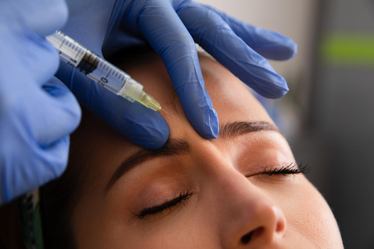 Young woman receiving a botox injection