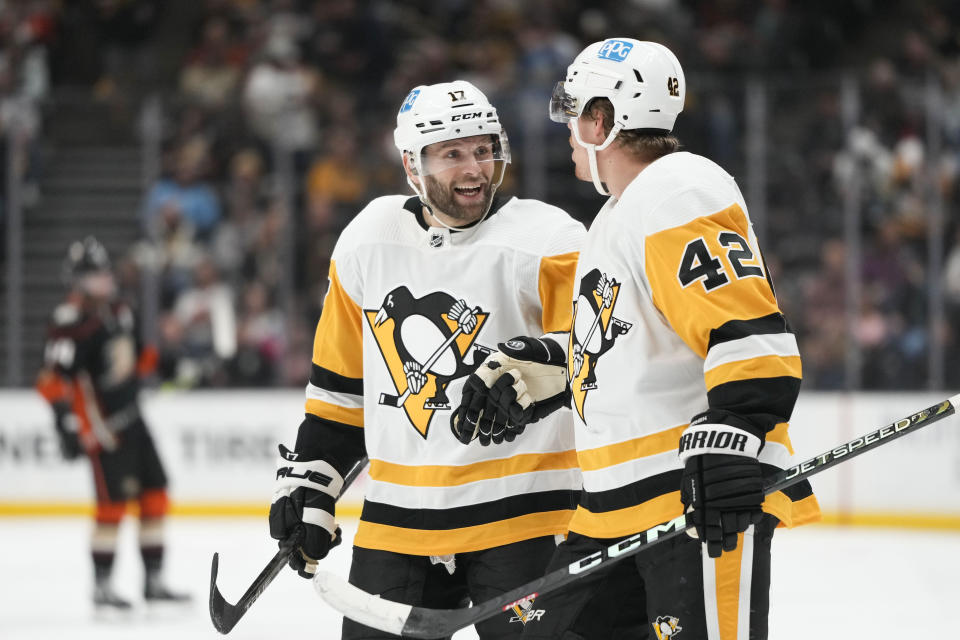 Pittsburgh Penguins' Kasperi Kapanen (42) celebrates after his goal with Bryan Rust (17) during the first period of an NHL hockey game against the Anaheim Ducks, Friday, Feb. 10, 2023, in Anaheim, Calif. (AP Photo/Jae C. Hong)