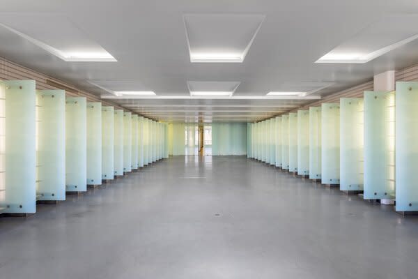 The open living area is lined with polished concrete floors and sandblasted glass panels.