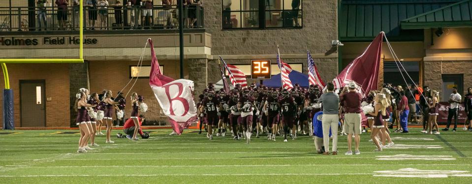 The Benedictine football team bursts onto the field prior its Aug. 19th game with Jenkins High at Memorial Stadium.