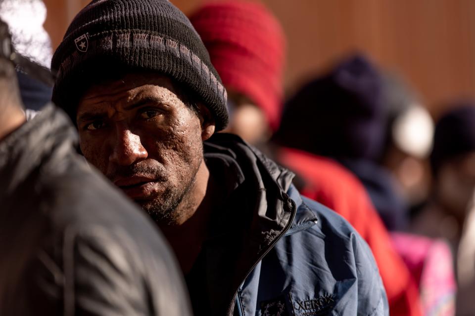 Migrants crossed the Rio Grande and wait in line to be processed by Customs and Border Protection to seek asylum in El Paso, Texas, on Thursday, Dec. 22, 2022.