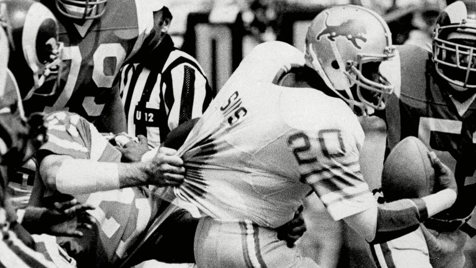 Mandatory Credit: Photo by Randy Rasmussen/AP/Shutterstock (6601080a)Billy Sims, Nolan Cromwell Detroit Lions Billy Sims (20) tries to break free from the hold of Los Angeles Rams Nolan Cromwell (21) during the second quarter at Anaheim Stadium, .