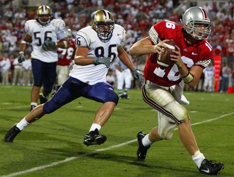 Ohio State quarterback Craig Krenzel runs away from the Washington defense on his way to his second touchdown of the game on August 30, 2003.