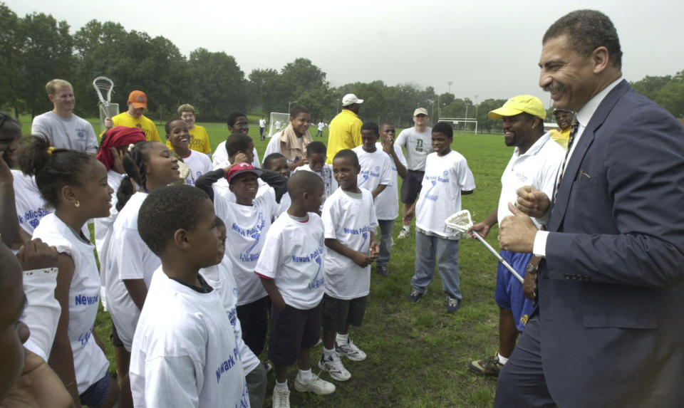 In this Aug. 1, 2000 photo, Elnardo Webster, Director of Summer Youth Development Program, gives a pep talk to the kids before the Lacrosse clinic of the school district's new Summer Youth Development Program Activities at West Side Park in Newark, N.J. Soon after Cory Booker became mayor of Newark, Webster, his former campaign aide and law partner, authored a November 2006 memo recommending new watershed board members. The memo, written on law firm letterhead that still listed Booker as a partner, advised the mayor to appoint a businessman who had played college football with Webster. (William Perlman/NJ Advance Media via AP)