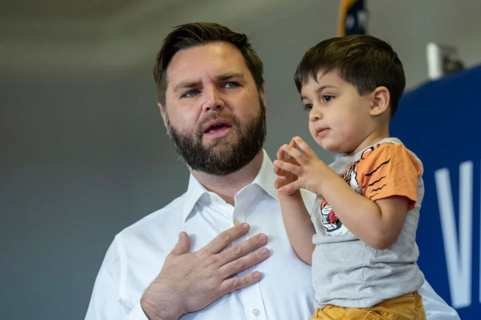 JD Vance holds his son, Vivek.