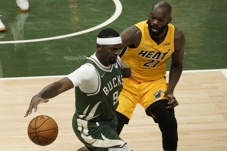 Milwaukee Bucks' Bobby Portis grabs the ball in front of Miami Heat's Dewayne Dedmon during the first half of Game 1 of their NBA basketball first-round playoff series Saturday, May 22, 2021, in Milwaukee. (AP Photo/Morry Gash)