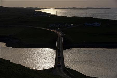 Cars travel over a bridge connecting mainland Shetland with west Burra on the Shetland Islands March 31, 2014. REUTERS/Cathal McNaughton