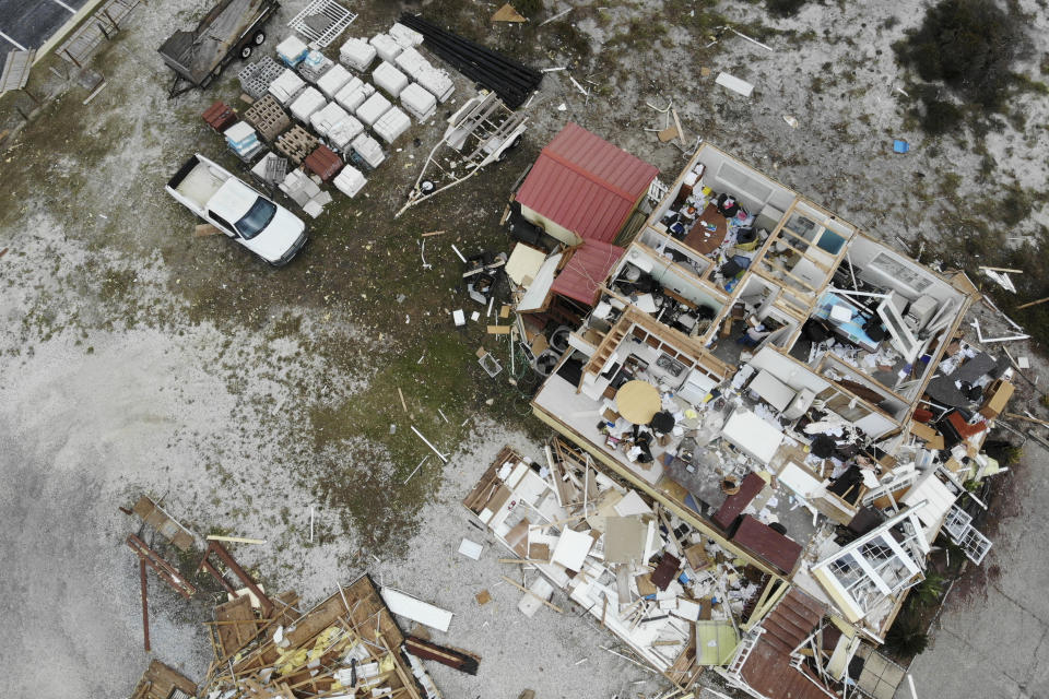 A damaged business is seen in the aftermath of Hurricane Sally, Thursday, Sept. 17, 2020, in Perdido Key, Fla. Rivers swollen by Hurricane Sally's rains threatened more misery for parts of the Florida Panhandle and south Alabama on Thursday, as the storm's remnants continued to dump heavy rains inland that spread the threat of flooding to Georgia and the Carolinas. (AP Photo/Angie Wang)