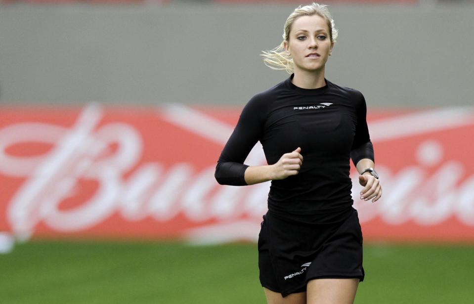 Brazil's referee assistant Fernanda Colombo Uliana warms up before the Brazilian championship soccer match between Atletico Mineiro and Cruzeiro in Belo Horizonte May 11, 2014. Uliana has just been granted FIFA official status by the refereeing committee of the Brazilian Football Confederation. REUTERS/Washington Alves (BRAZIL - Tags: SPORT SOCCER)