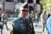 <p>A veteran enjoys a cigar as he marches up Fifth Avenue during the Veterans Day parade in New York City on Nov. 11, 2017. (Photo: Gordon Donovan/Yahoo News) </p>