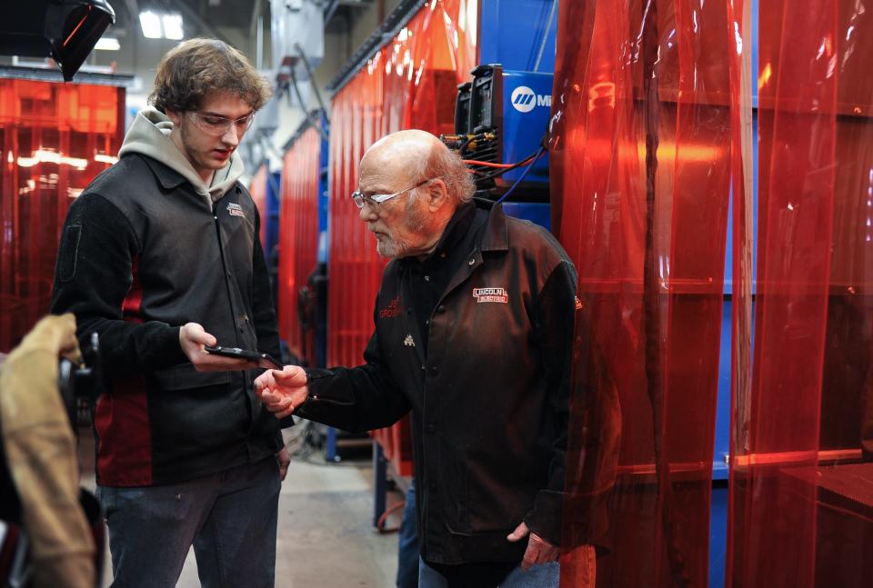 Wilson Talent Center senior Mason Fjoser works with welding teacher Jeff Grossman, Thursday, April 4, 2024, in the welding technology program center.