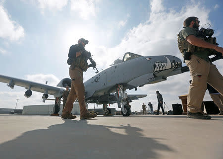 U.S. military personnel pass in front of a U.S. A-10 aircraft, one of a squadron that has arrived to step up the fight against the Taliban, at the Kandahar air base, Afghanistan January 23, 2018. REUTERS/Omar Sobhani