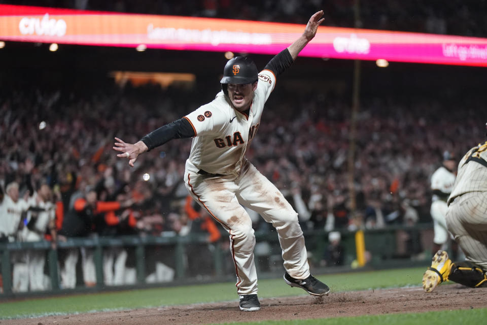 San Francisco Giants' Mike Yastrzemski celebrates after scoring against the San Diego Padres during the ninth inning of a baseball game in San Francisco, Monday, June 19, 2023. (AP Photo/Jeff Chiu)