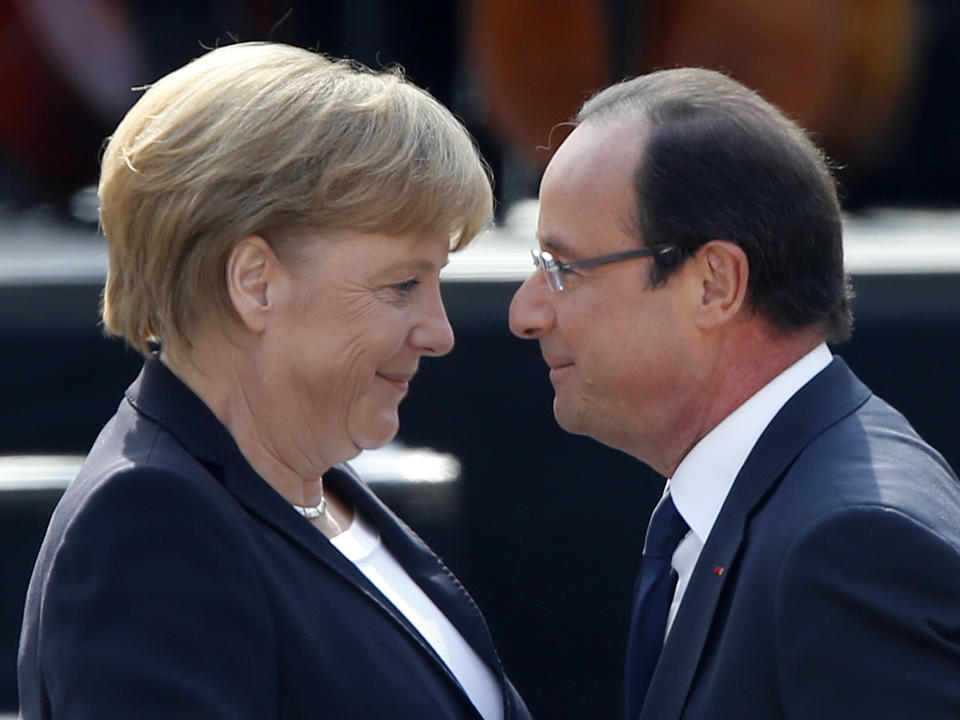 German Chancellor Angela Merkel, left, and French President Francois Hollande hug in the yard of the castle in Ludwigsburg, Germany, Saturday, Sept.22, 2012. Merkel and Hollande attend the celebration of the 50th anniversary of former French President Charles de Gaulle's speech to the youth of Germany. (AP Photo/Michael Probst)