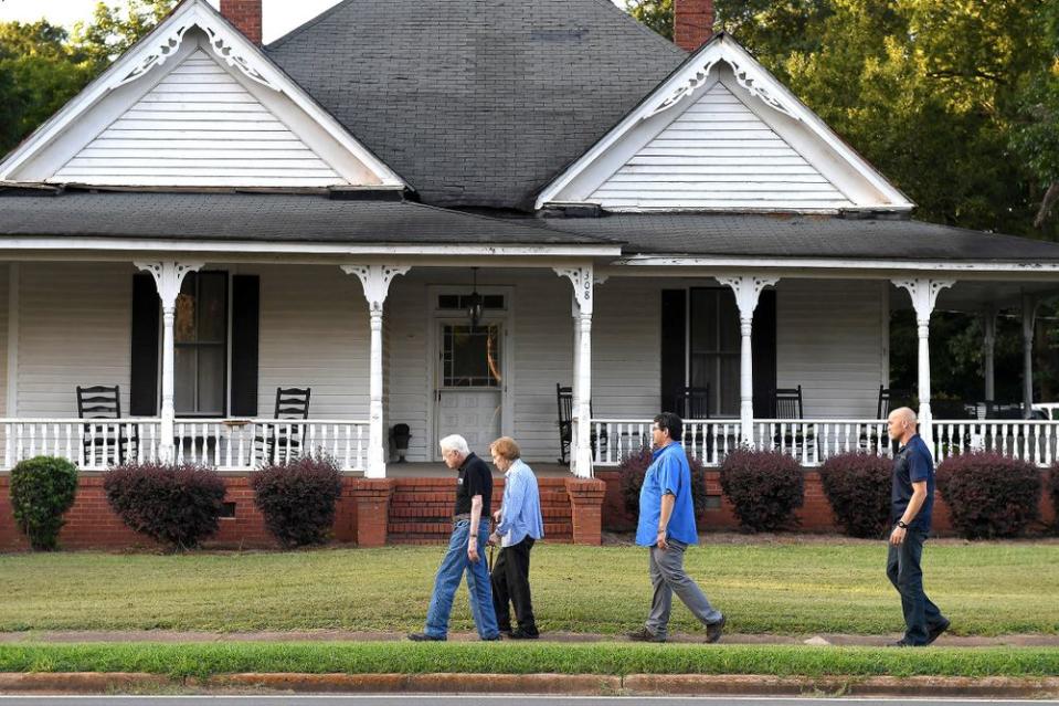 Jimmy and Rosalynn Carter walk home from dinner at a friend's home, along with Secret Service