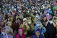 Pro-democracy protesters clap during a rally at Sanam Luang in Bangkok, Thailand, Saturday, Sept. 19, 2020. Protesters gathered Saturday in Bangkok for the most ambitious rally so far in a pro-democracy campaign that has shaken up the government and the country's conservative establishment. (AP Photo/Gemunu Amarasinghe)