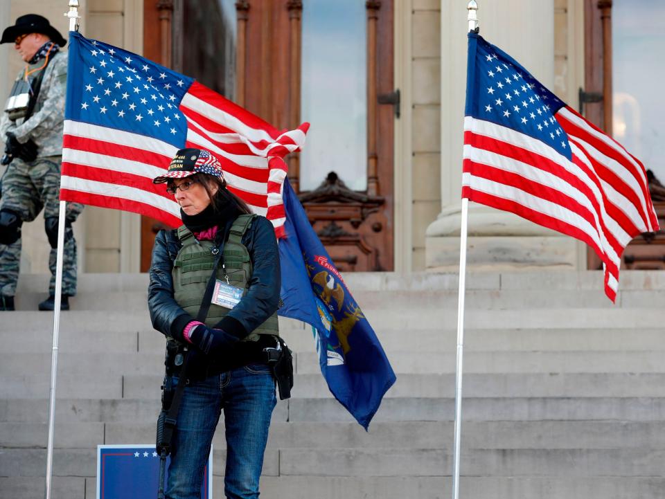 People gather at the Michigan State Capitol for a “Stop the Steal” rally in support of US President Donald Trump on 14 November 2020, in Lansing, Michigan. - Supporters are backing Mr Trump’s false claim that the 3 November election was fraudulent (AFP via Getty Images)