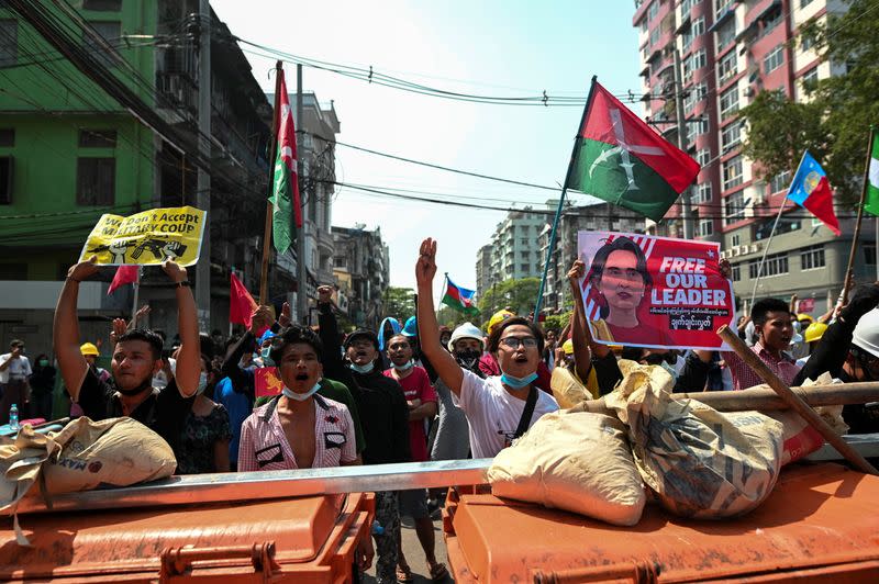 Protesters flash three-finger salutes during a rally against the military coup in Yangon