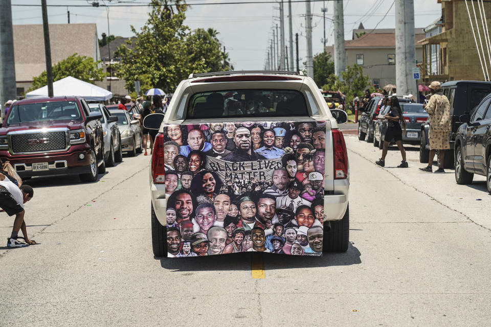 A Black Lives Matter banner is seen on the back of a pickup truck during Juneteenth Parade in Galveston, Texas.