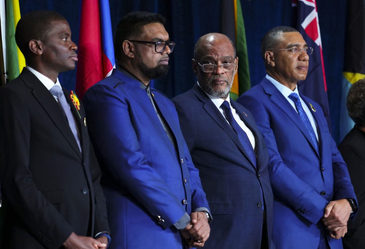Prime Minister of Grenada Dickon Mitchell, left to right, President of Guyana Irfaan Ali, Prime Minister of Haiti Ariel Henry and Prime Minister of Jamaica Andrew Holness take part in the opening ceremony of the Conference of Heads of Government of the Caribbean Community in Nassau, Bahamas, on Wednesday, Feb. 15, 2023. (Sean Kilpatrick/The Canadian Press via AP)