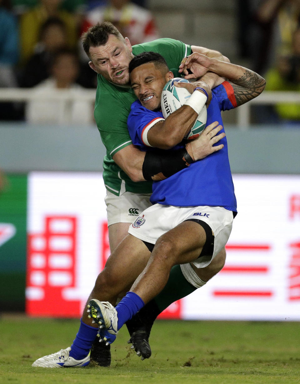 Ireland's Cian Healy tackles Samoa's Dwayne Polataivao during the Rugby World Cup Pool A game at Fukuoka Hakatanomori Stadium between Ireland and Samoa, in Fukuoka, Japan, Saturday, Oct. 12, 2019. (AP Photo/Aaron Favila)