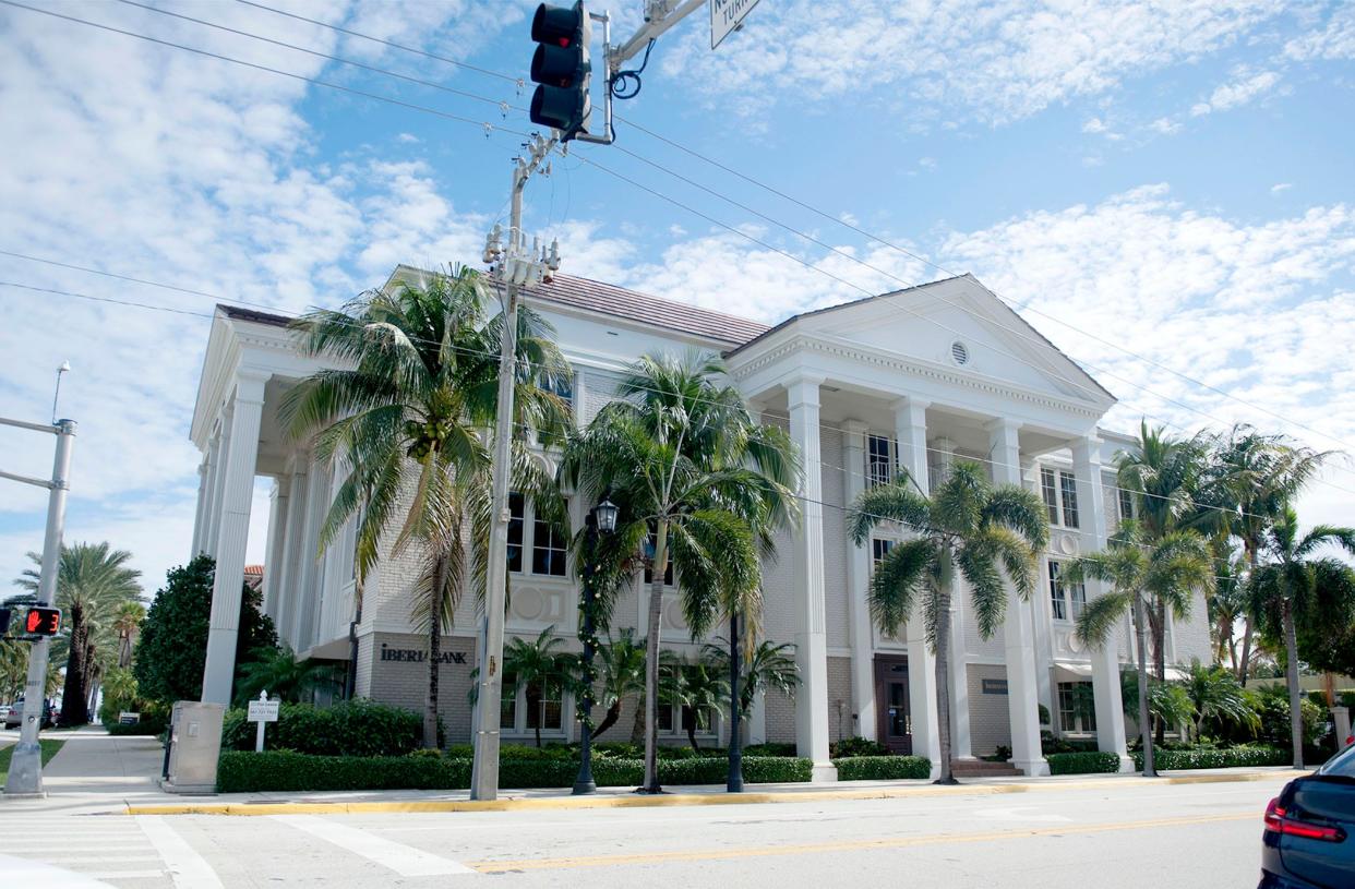 A company affiliated with Frisbie Group is one of the co-owners of this bank building at 180 Royal Palm Way on the corner of South County Road, property records show.