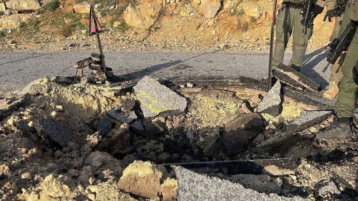 A view of a crater on a damaged road, after Iran's mass drone and missile attack, at a location given as Hermon area, Israel (via REUTERS)