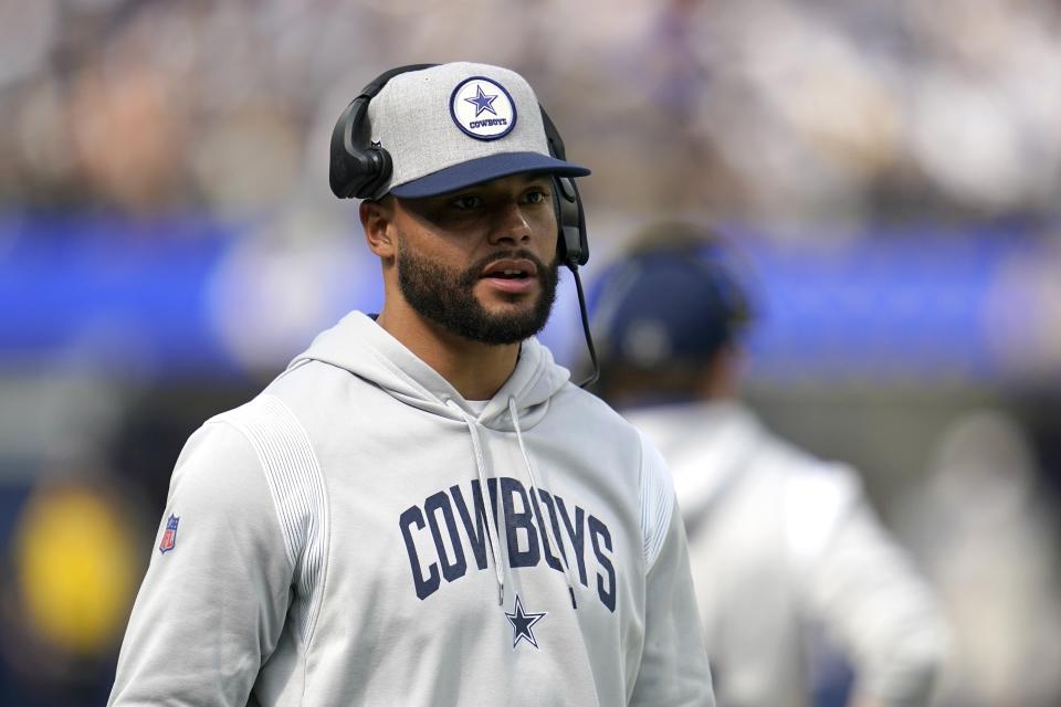 Dallas Cowboys quarterback Dak Prescott watches play from the sideline in the first half of an NFL football game against the Los Angeles Rams, Sunday, Oct. 9, 2022, in Inglewood, Calif. (AP Photo/Ashley Landis)