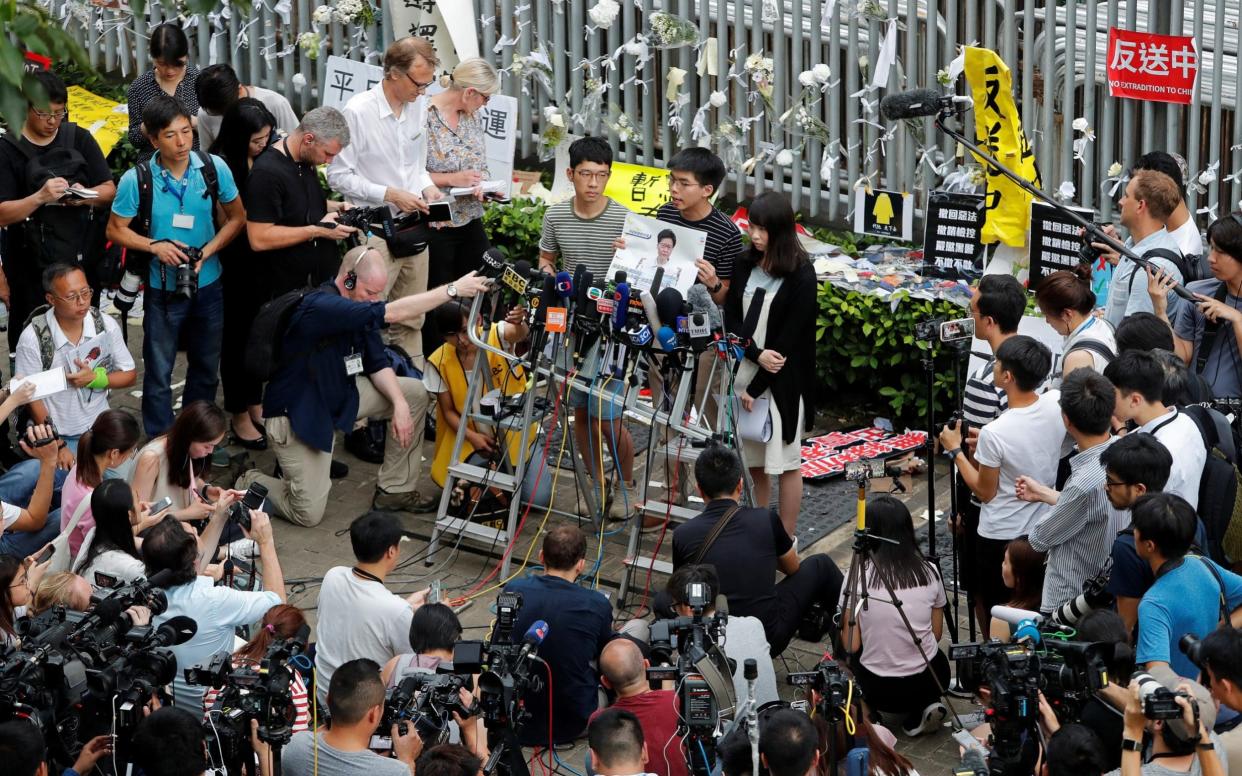 Pro-democracy activists Nathan Law, Joshua Wong and Agnes Chow held a press conference in Hong Kong - REUTERS
