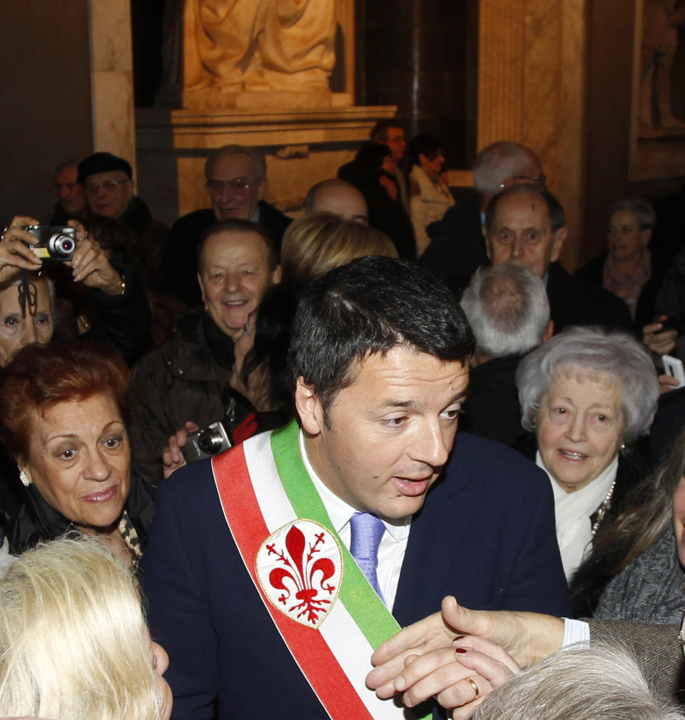 Florence mayor Matteo Renzi greets couples that have been married for over 50 years during a ceremony on Valentine's Day in Florence, Italy, Friday, Feb. 14, 2014. Outgoing Premier Enrico Letta hosted his final cabinet meeting Friday after his party sacked him in a stunning power play to put Florence's dynamic young mayor at the helm of the Italian government. His rival and the architect of his downfall spent the day doing what he does best, charming ordinary Italians by celebrating Valentine's Day at Florence's city hall with hundreds of married couples. (AP Photo/Fabrizio Giovannozzi)