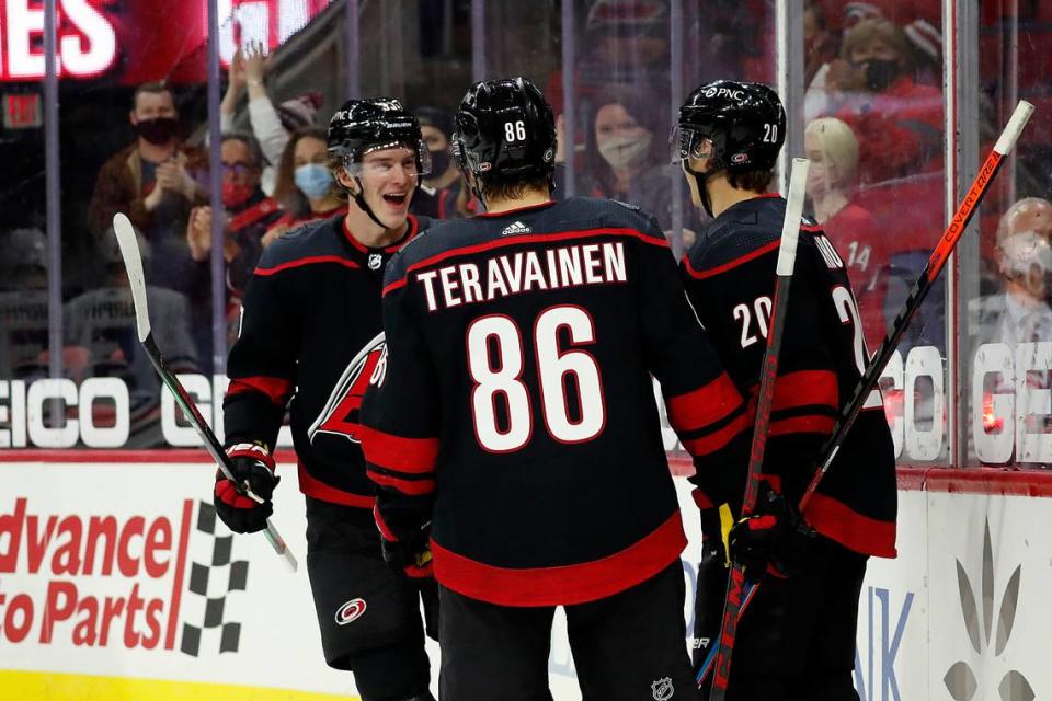 Carolina Hurricanes’ Andrei Svechnikov (37) comes to celebrate with teammates Teuvo Teravainen (86) and Sebastian Aho (20) a goal by Aho during the second period of an NHL hockey game in Raleigh, N.C., Monday, May 3, 2021. (AP Photo/Karl B DeBlaker)