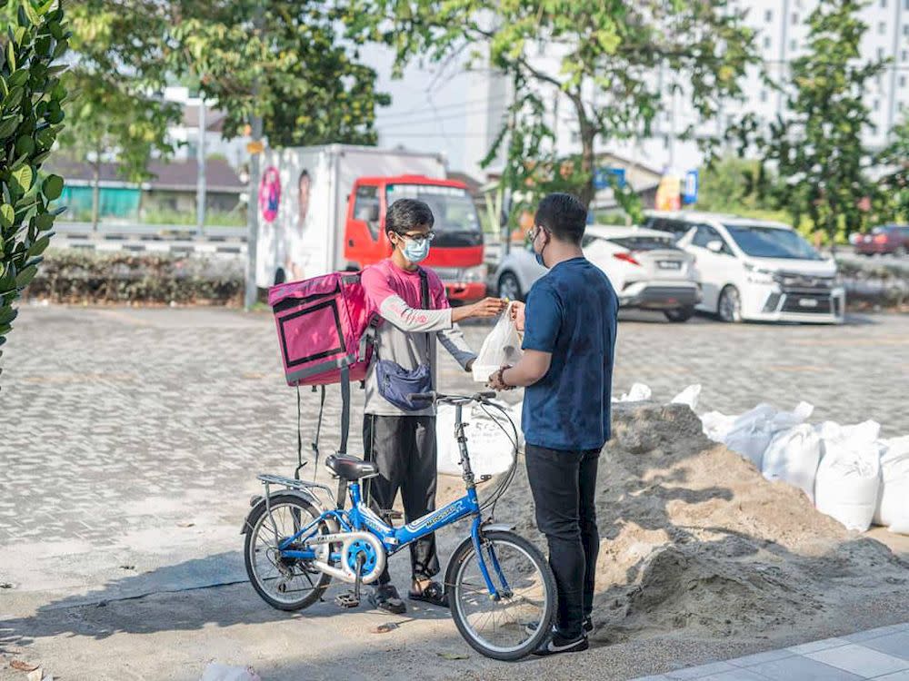 Last week, Steven Sim presented a motorcycle to a Foodpanda delivery rider known only as Mohamad, whom he said was struggling to get by with a RM500 monthly wage. — Photo via Facebook/ Steven Sim Chee Keong