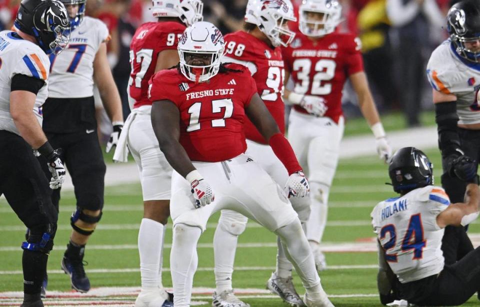 Fresno State’s Johnny Hudson Jr., center, dances after tackling Boise State running back George Holani, on the ground to the right, in the Battle of the Milk Can Saturday, Nov. 4, 2023 in Fresno.