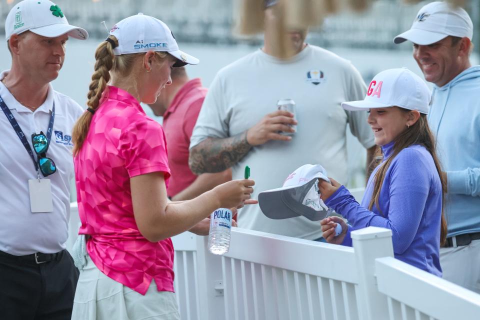 Dover High School senior Carys Fennessy signs an autographed hat for a young fan after completing the second round the LPGA's FM Global Championship at TPC Boston Friday, Aug. 30, 2024 in Norton, Massachusetts.