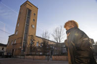 A woman covers her face as she walks in Codogno, near Lodi in Northern Italy, Friday, Feb. 21,2020. Health officials reported the country's first cases of contagion of COVID-19 in people who had not been in China. The hospital in Codogno is one of the hospitals - along with specialized Sacco Hospital in Milan - which is hosting the infected persons and the people that were in contact with them and are being isolated. (AP Photo/Luca Bruno)