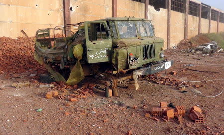 A damaged military truck that belonged to forces loyal to Syria's President Bashar al-Assad is seen in Qarmeed camp after Islamist rebel fighters took control of the area, April 26, 2015. REUTERS/Abdalghne Karoof