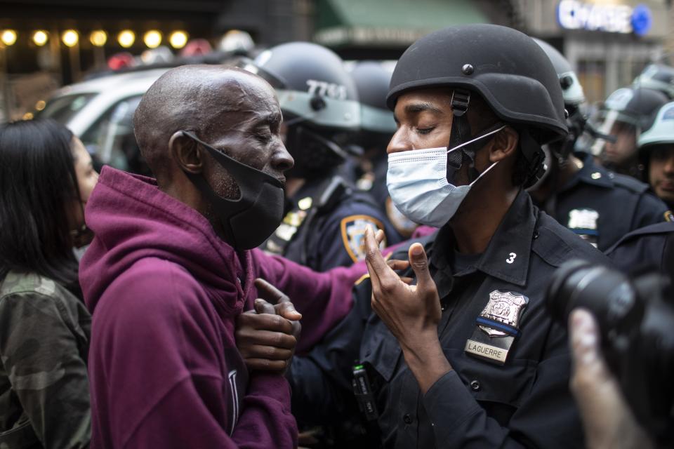 FILE - A protester and a police officer greet in the middle of a standoff in New York, June 2, 2020, during a solidarity rally calling for justice over the death of George Floyd, a Black man who died earlier that year after Minneapolis police officers restrained him. The death of Tyre Nichols in Memphis stands apart from some other police killings because the young Black man was beaten by Black officers. But the fact that Black officers killed a Black man didn’t remove racism from the situation. (AP Photo/Wong Maye-E, File)