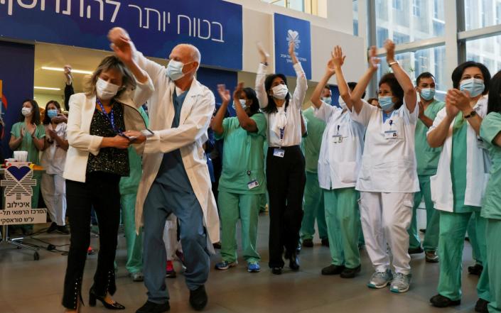 Medical teams celebrate before receiving&#xa0;coronavirus vaccines as Israel kicks off its coronavirus vaccination drive, at Tel Aviv Sourasky Medical Center - Ronen Zvulun/Reuters