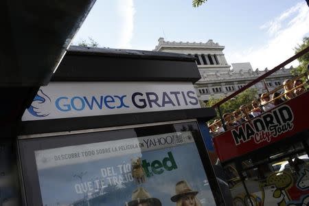 A sign advertising Spanish wireless networks provider Gowex is next to a tourist bus in Madrid July 6, 2014. REUTERS/Juan Medina